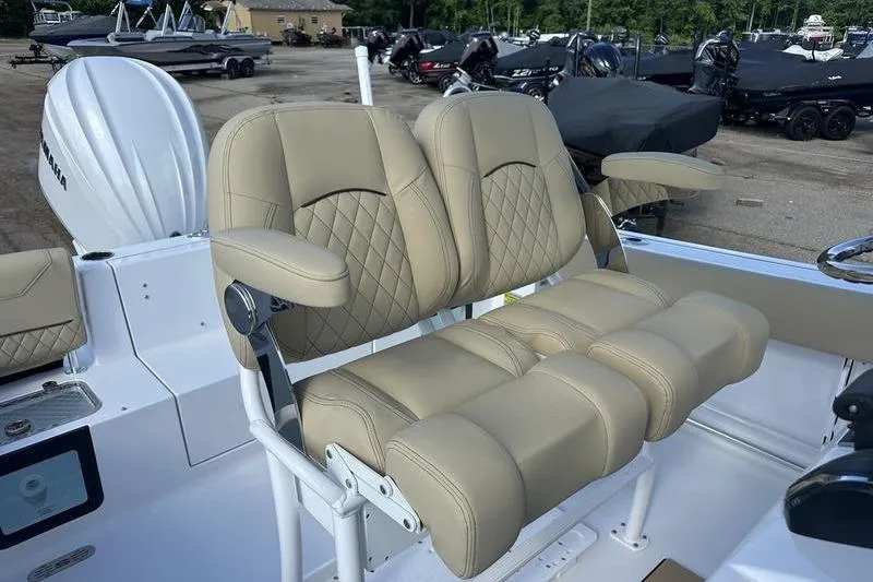 Slide: The Image of 2026 Sportsman Heritage 231 Center Console boat with beige cushioned seating. - 24