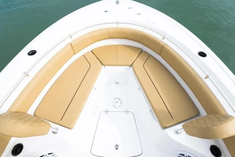Slide: The Image of 2026 Sportsman Heritage 231 Center Console boat with tan cushioned seating. - 28