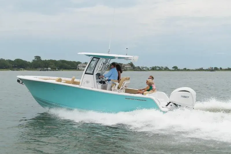 Slide: The Image of 2026 Sportsman Heritage 231 Center Console boat cruising on a calm lake. - 29
