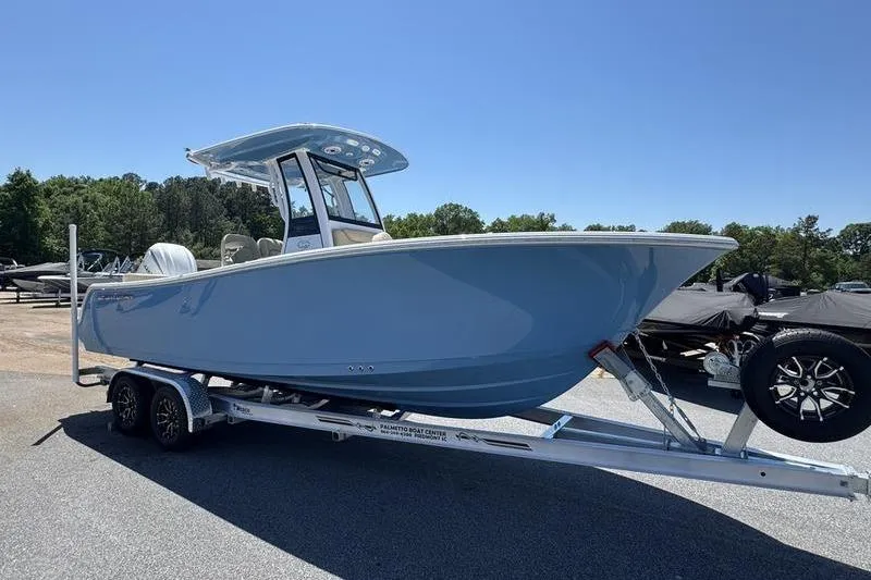 Slide: The Image of 2026 Sportsman Heritage 231 Center Console boat on trailer, parked outdoors. - 30