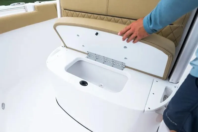 Slide: The Image of 2026 Sportsman Heritage 231 Center Console boat seat storage compartment being opened. - 33