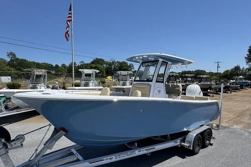 Slide: The Image of 2026 Sportsman Heritage 231 Center Console boat on trailer, displayed outdoors under clear sky. - 4