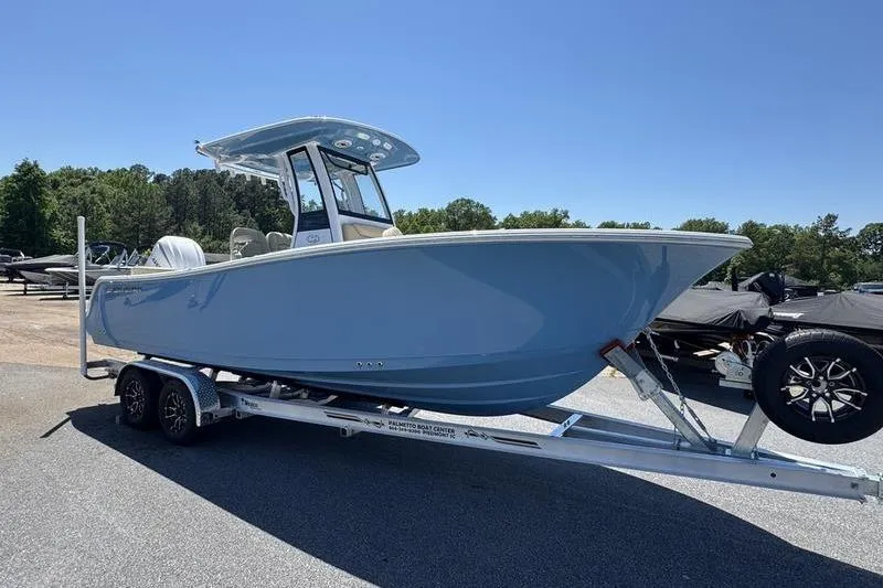 Slide: The Image of 2026 Sportsman Heritage 231 Center Console boat on trailer, parked outdoors. - 6
