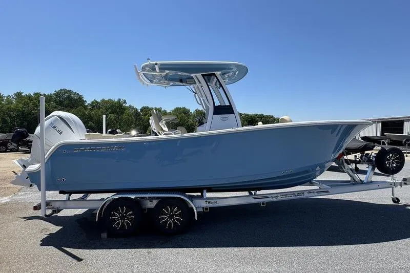 Slide: The Image of 2026 Sportsman Heritage 231 Center Console boat on trailer, parked outdoors. - 8