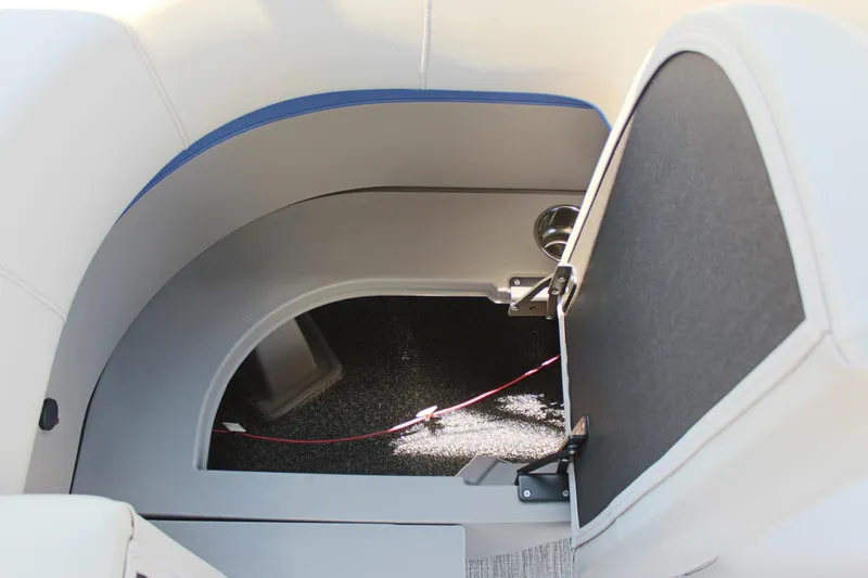 Slide: The Image of Interior storage compartment of 2026 Qwest Lanai 816 boat, featuring sleek design and cup holder. - 10