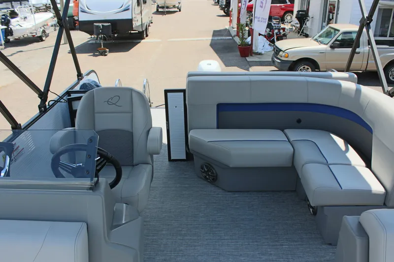 Slide: The Image of 2026 Qwest Lanai 816 pontoon boat interior with plush seating and modern steering console. - 19