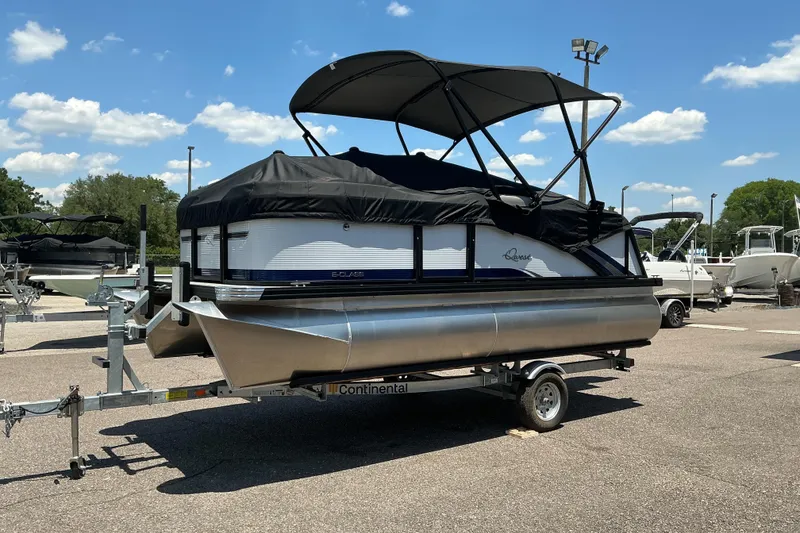 Slide: The Image of 2026 Qwest Lanai 816 pontoon boat on trailer under clear blue sky. - 22