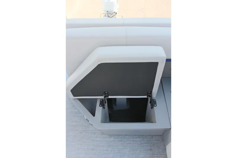 Slide: The Image of Open storage compartment on 2026 Qwest Lanai 816 boat seat. - 9