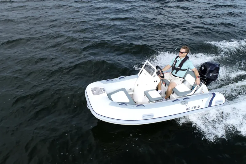 Slide: The Image of 2026 Highfield Classic 360 FCT boat cruising on open water. - 2