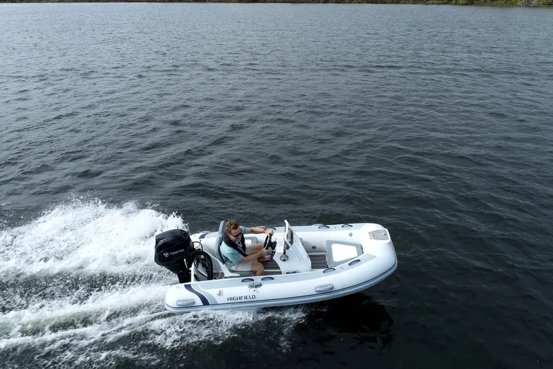 Slide: The Image of 2026 Highfield Classic 360 FCT boat cruising on open water. - 3