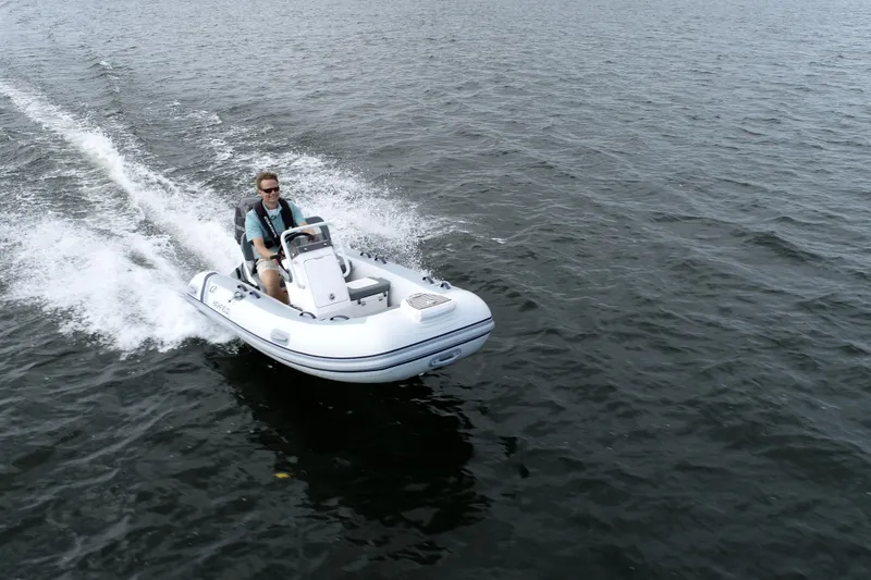 Slide: The Image of 2026 Highfield Classic 360 FCT boat cruising on open water with driver. - 4