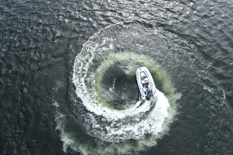 Slide: The Image of Aerial view of 2026 Highfield Classic 360 FCT boat creating circular wake pattern. - 5