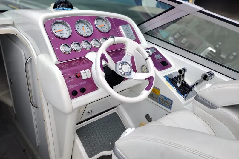 Slide: The Image of 2006 Formula 353 FASTech boat cockpit with purple dashboard and white steering wheel. - 12