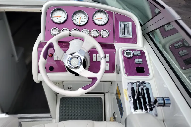 Slide: The Image of 2006 Formula 353 FASTech boat dashboard with purple accents and multiple gauges. - 13