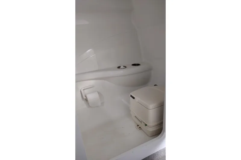 Slide: The Image of Compact bathroom in a 2006 Formula 353 FASTech boat, featuring a portable toilet. - 21