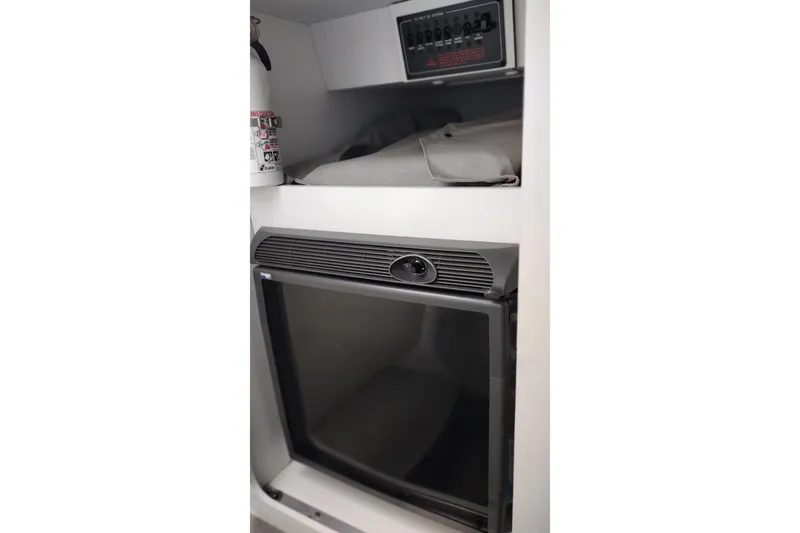 Slide: The Image of 2006 Formula 353 FASTech cabin interior with mini fridge and control panel. - 23