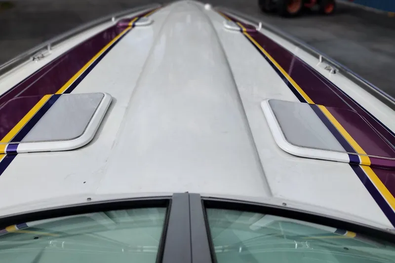 Slide: The Image of 2006 Formula 353 FASTech boat deck with purple and yellow stripes, featuring sleek design. - 26