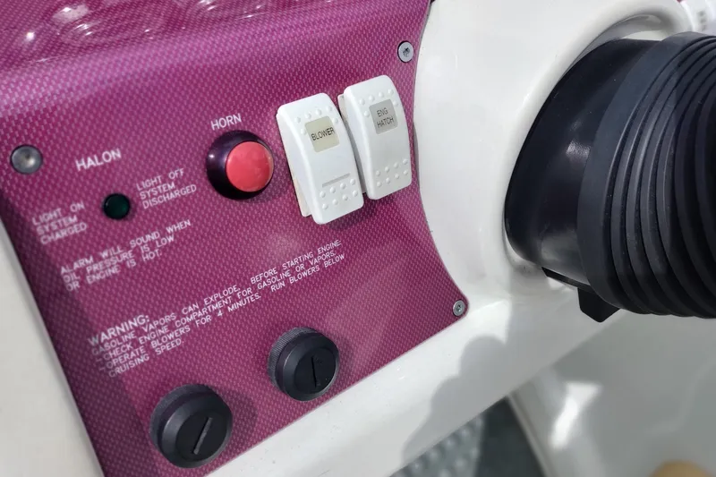 Slide: The Image of Control panel of a 2006 Formula 353 FASTech boat with switches and warning labels. - 39