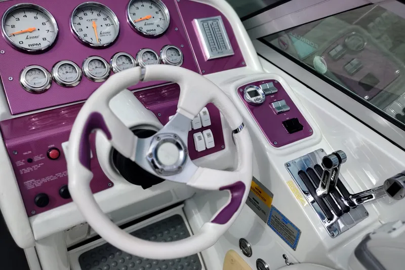 Slide: The Image of 2006 Formula 353 FASTech boat dashboard with purple accents and detailed gauges. - 40