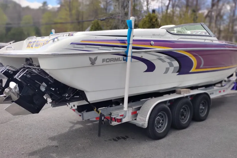 Slide: The Image of 2006 Formula 353 FASTech speedboat on trailer, featuring vibrant purple and yellow graphics. - 5
