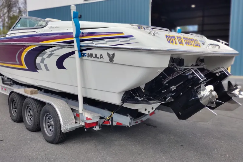 Slide: The Image of 2006 Formula 353 FASTech boat on trailer, featuring vibrant graphics and dual propellers. - 7