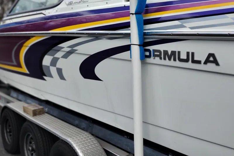 Slide: The Image of 2006 Formula 353 FASTech boat with colorful graphics on a trailer. - 8