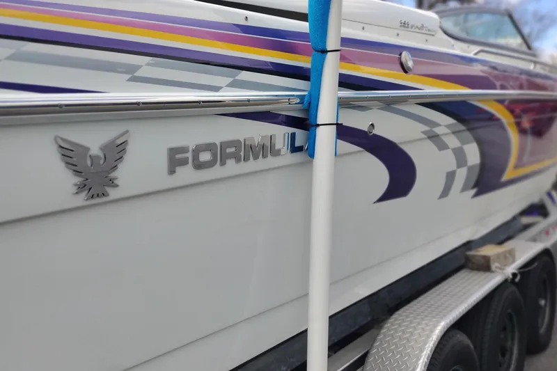 Slide: The Image of 2006 Formula 353 FASTech boat with vibrant graphics on a trailer. - 9