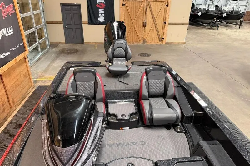 Slide: The Image of 2022 Caymas CX 19 boat interior with sleek seating and modern design in a showroom. - 3