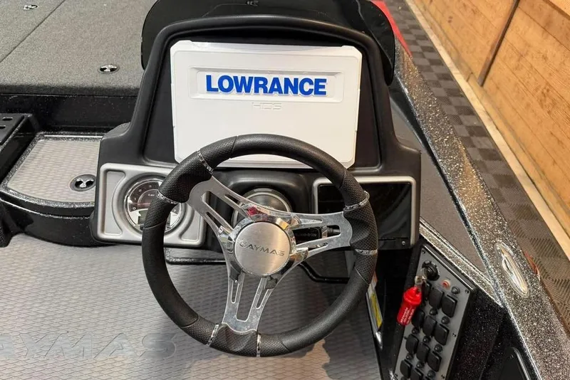 Slide: The Image of 2022 Caymas CX 19 boat dashboard with Lowrance display and steering wheel. - 5