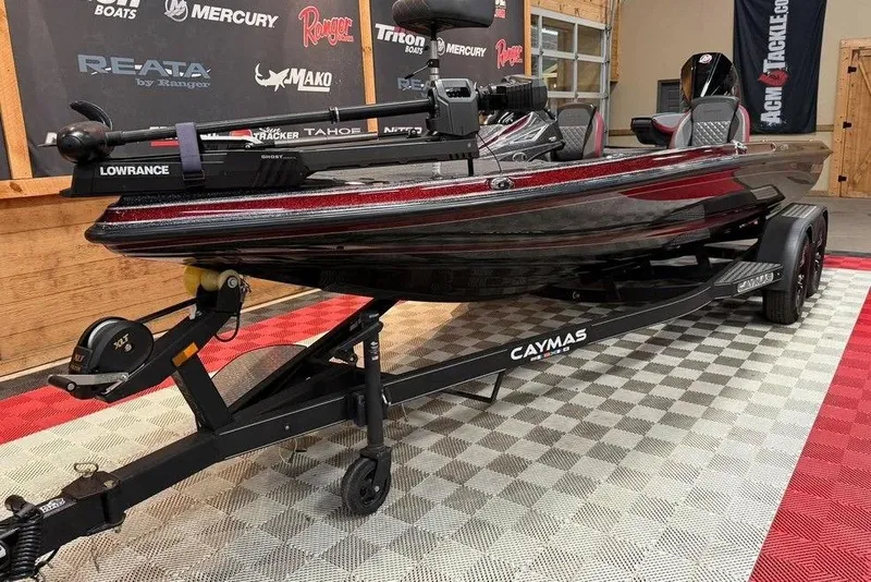 Slide: The Image of 2022 Caymas CX 19 boat on trailer, featuring Lowrance equipment, displayed indoors. - 7