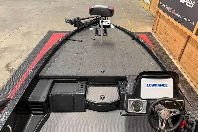 Slide: The Image of 2022 Caymas CX 19 boat interior with Lowrance electronics and steering wheel. - 8