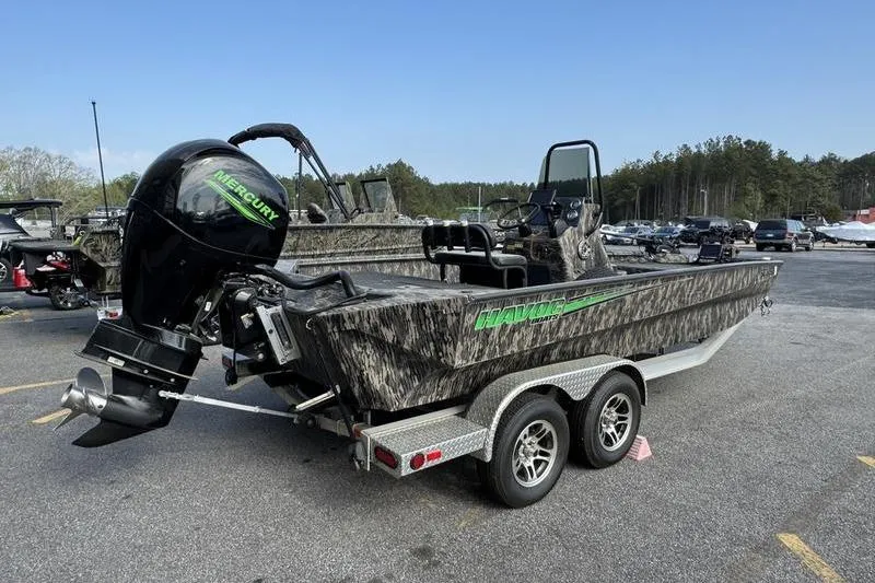 Slide: The Image of 2023 Havoc 1756 MRST boat with Mercury engine on a trailer in a parking lot. - 14