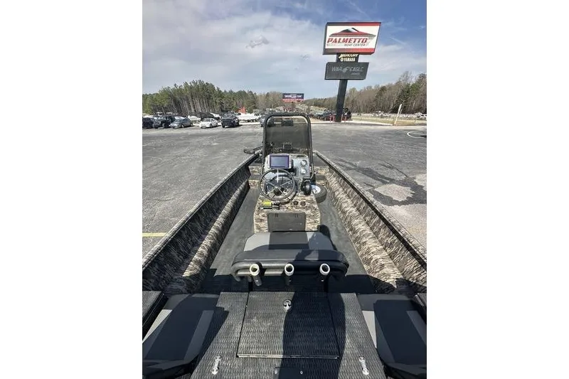 Slide: The Image of 2023 Havoc 1756 MRST boat with camo interior, parked at dealership lot. - 2