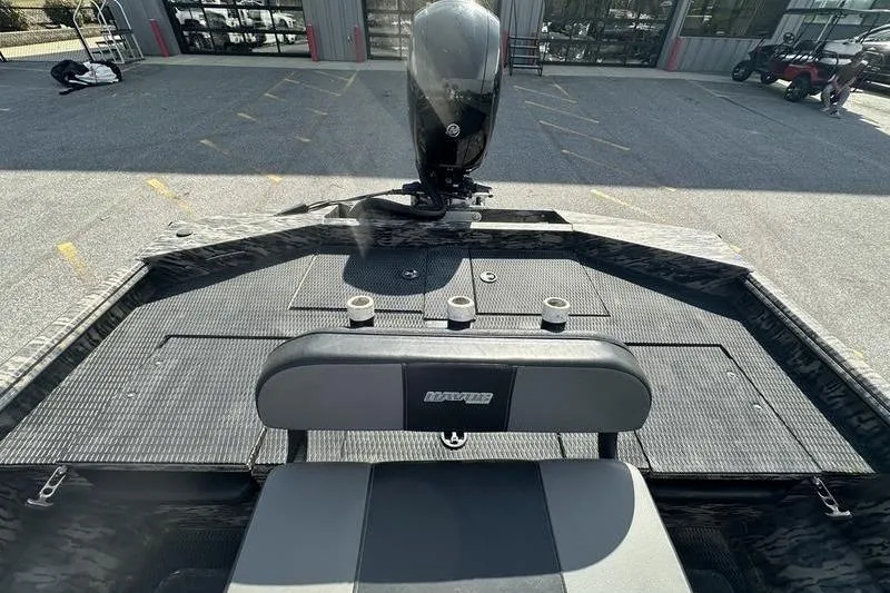 Slide: The Image of 2023 Havoc 1756 MRST boat interior with motor and seating, parked outdoors. - 5