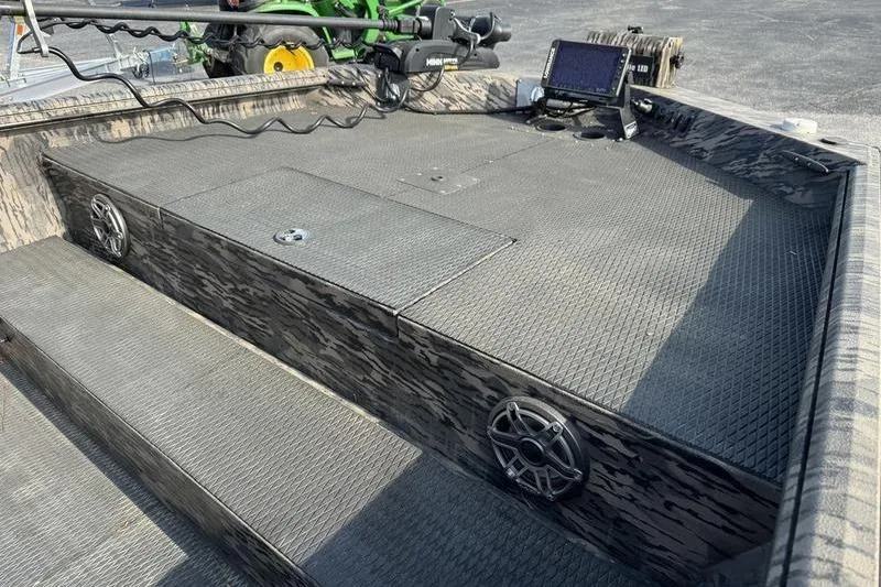 Slide: The Image of 2023 Havoc 1756 MRST boat interior with speakers, control panel, and textured flooring. - 6