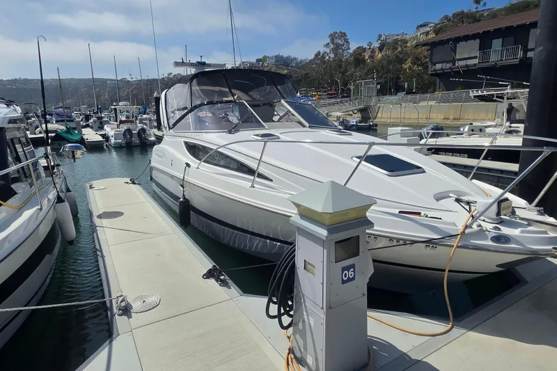 The Image of 2000 Bayliner 2855 Ciera docked at marina, surrounded by other boats. - 0