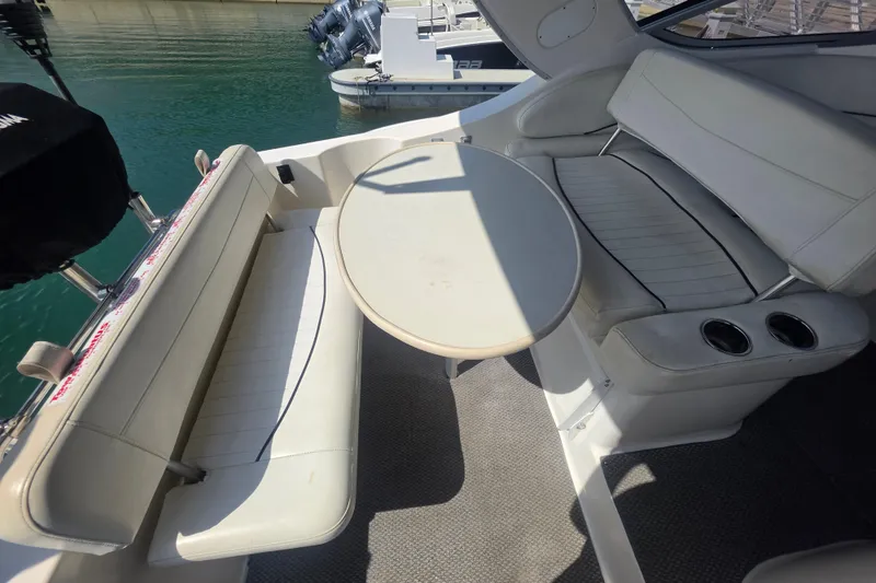 Slide: The Image of 2000 Bayliner 2855 Ciera boat interior with white seating and round table. - 10