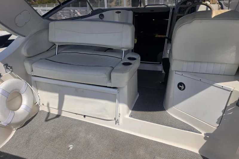 Slide: The Image of Interior of a 2000 Bayliner 2855 Ciera boat with white seating and life preserver. - 14