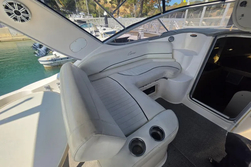 Slide: The Image of Interior of a 2000 Bayliner 2855 Ciera boat with white seating and cup holders. - 15