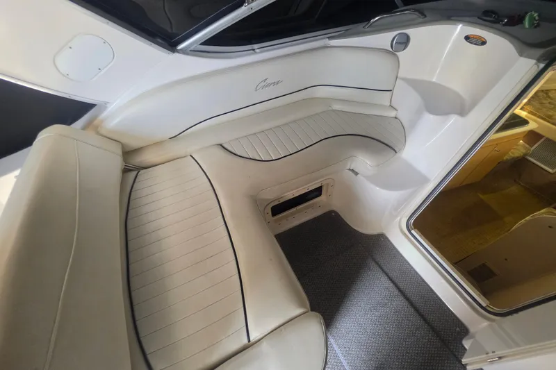 Slide: The Image of Interior seating of a 2000 Bayliner 2855 Ciera boat, featuring white cushioned seats. - 16