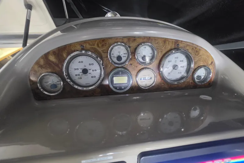 Slide: The Image of Dashboard of a 2000 Bayliner 2855 Ciera boat with gauges and controls. - 18