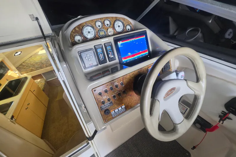 Slide: The Image of Cockpit of 2000 Bayliner 2855 Ciera with steering wheel and navigation controls. - 19