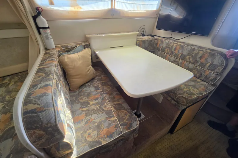 Slide: The Image of Interior of a 2000 Bayliner 2855 Ciera with a cozy dining area. - 24