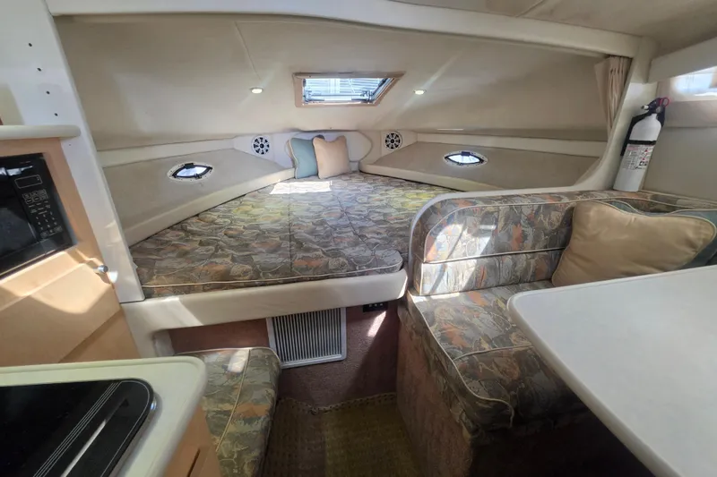 Slide: The Image of Interior of 2000 Bayliner 2855 Ciera boat with cozy sleeping area and seating. - 25