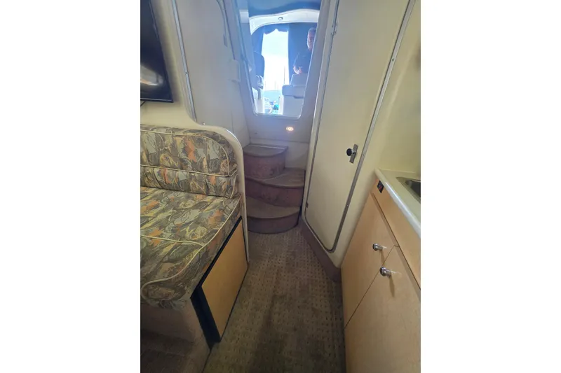 Slide: The Image of Interior of 2000 Bayliner 2855 Ciera boat with seating, stairs, and kitchenette. - 26
