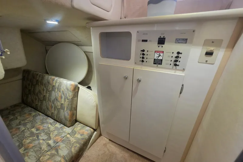Slide: The Image of Interior of 2000 Bayliner 2855 Ciera boat with control panel and seating area. - 27