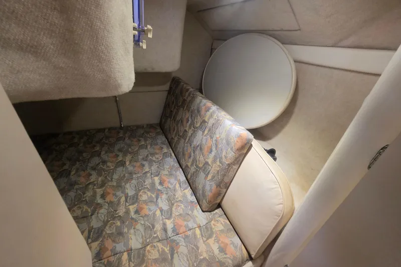 Slide: The Image of Interior cabin of 2000 Bayliner 2855 Ciera with patterned upholstery and compact design. - 28