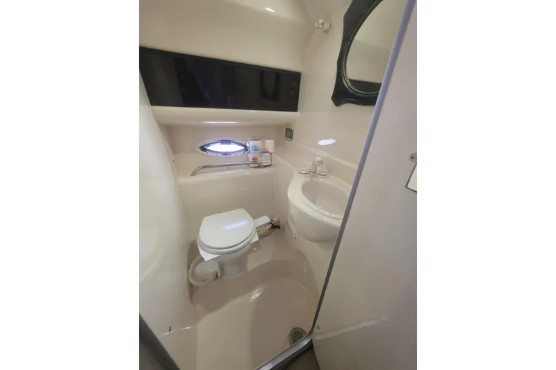 Slide: The Image of Bathroom interior of 2000 Bayliner 2855 Ciera boat, featuring toilet and sink. - 29