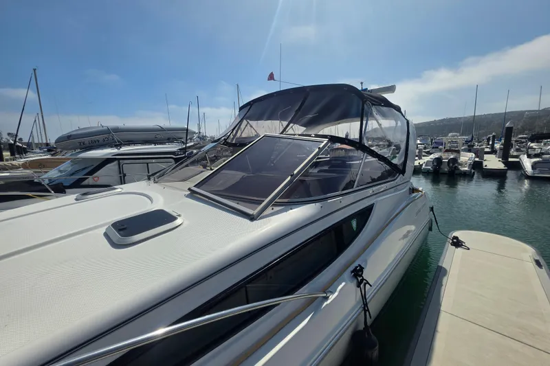 Slide: The Image of 2000 Bayliner 2855 Ciera docked at marina under clear blue sky. - 4