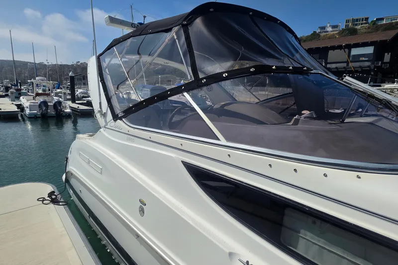 Slide: The Image of 2000 Bayliner 2855 Ciera boat docked at marina under clear blue sky. - 5